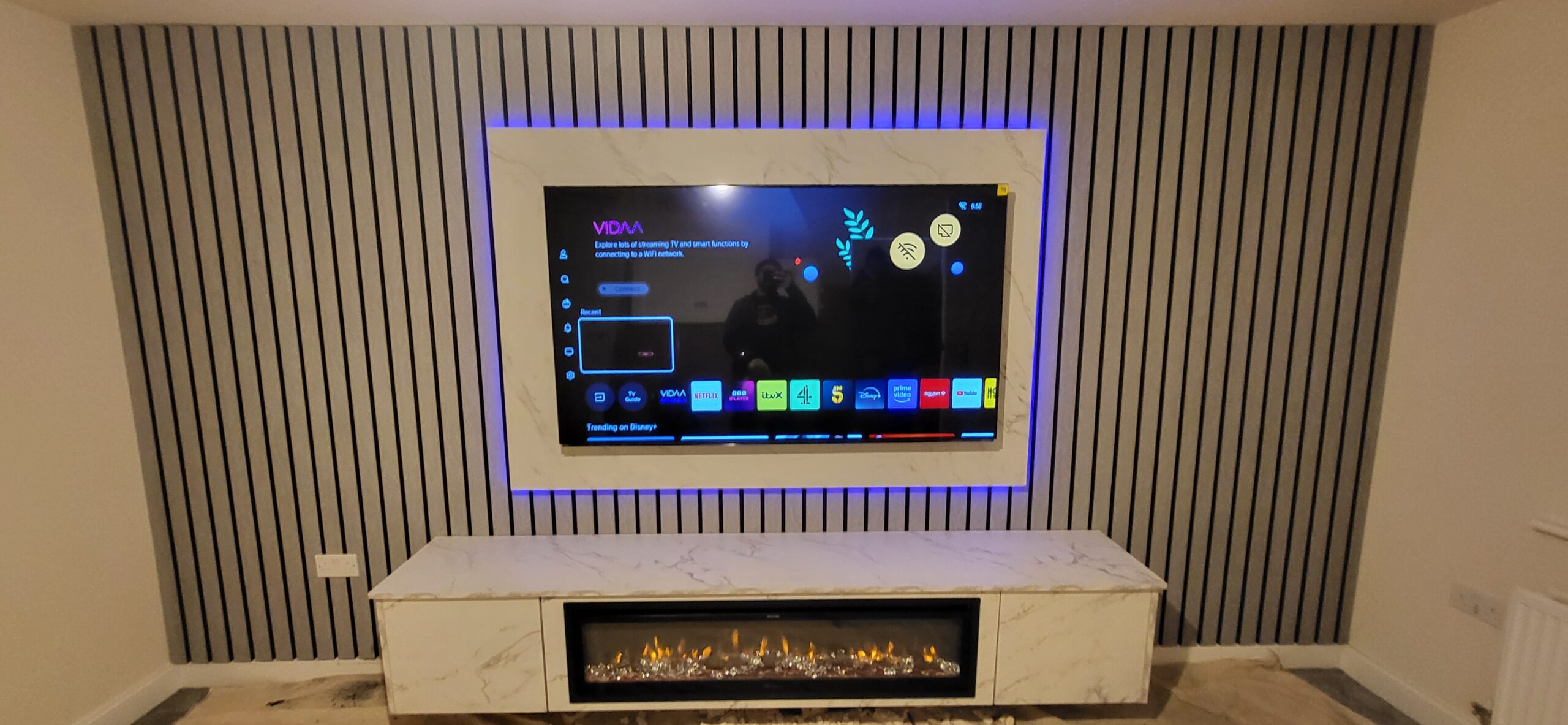 Slat Panel Media Wall With Fireplace and LED Frame
